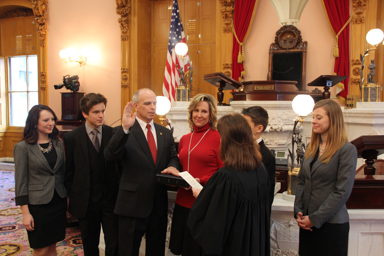 Rep. Koehler being sworn in, surrounded by his family