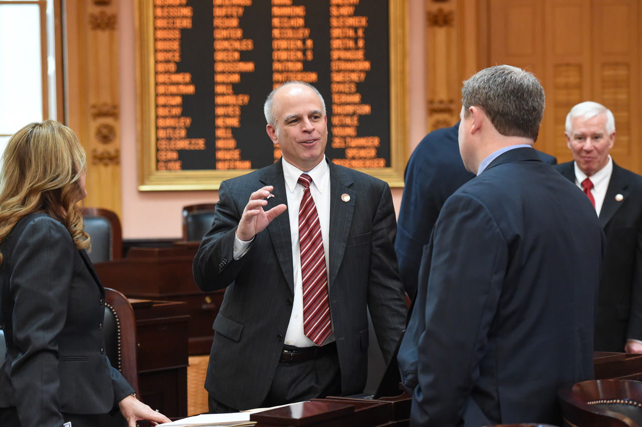 Rep. Koehler speaks with other representatives before House Session.