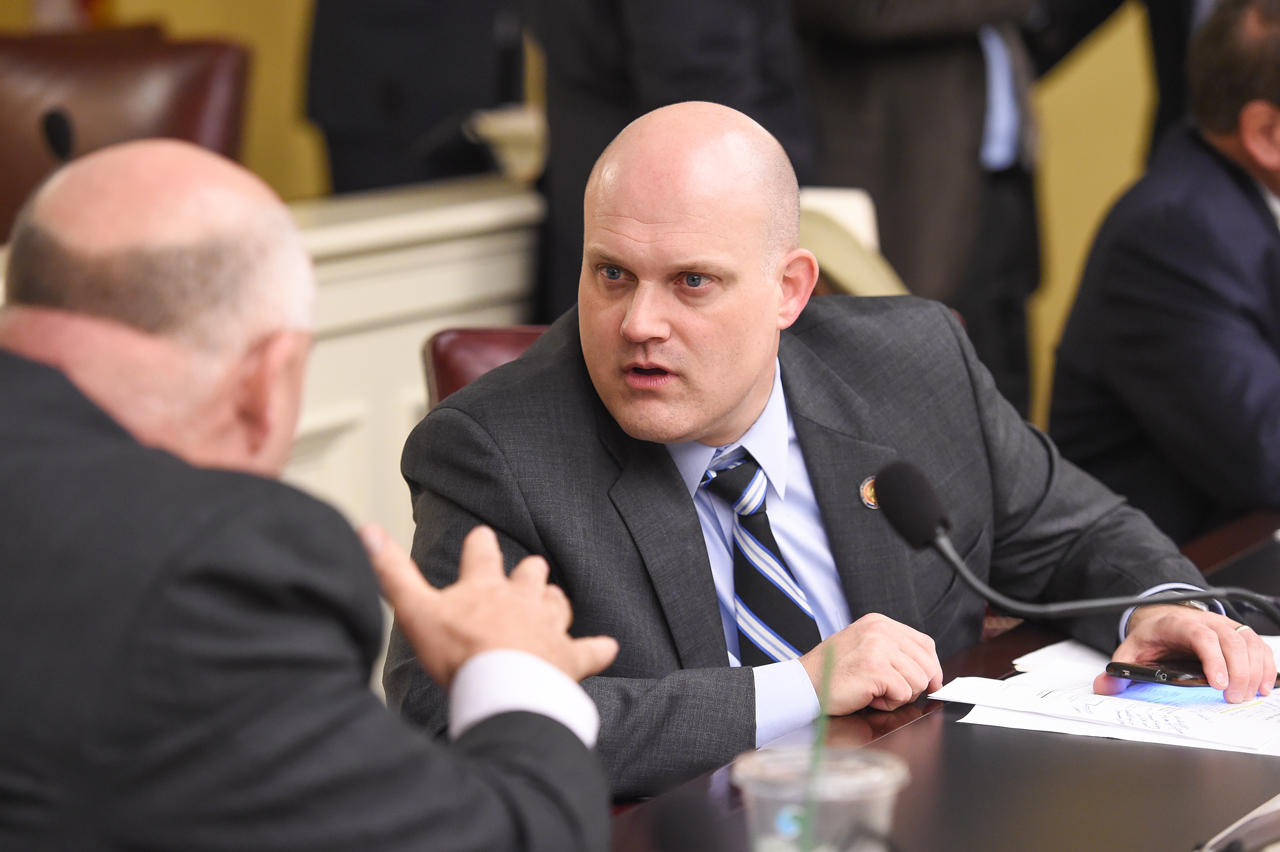 Rep. Wiggam consults with another representative during hearing.