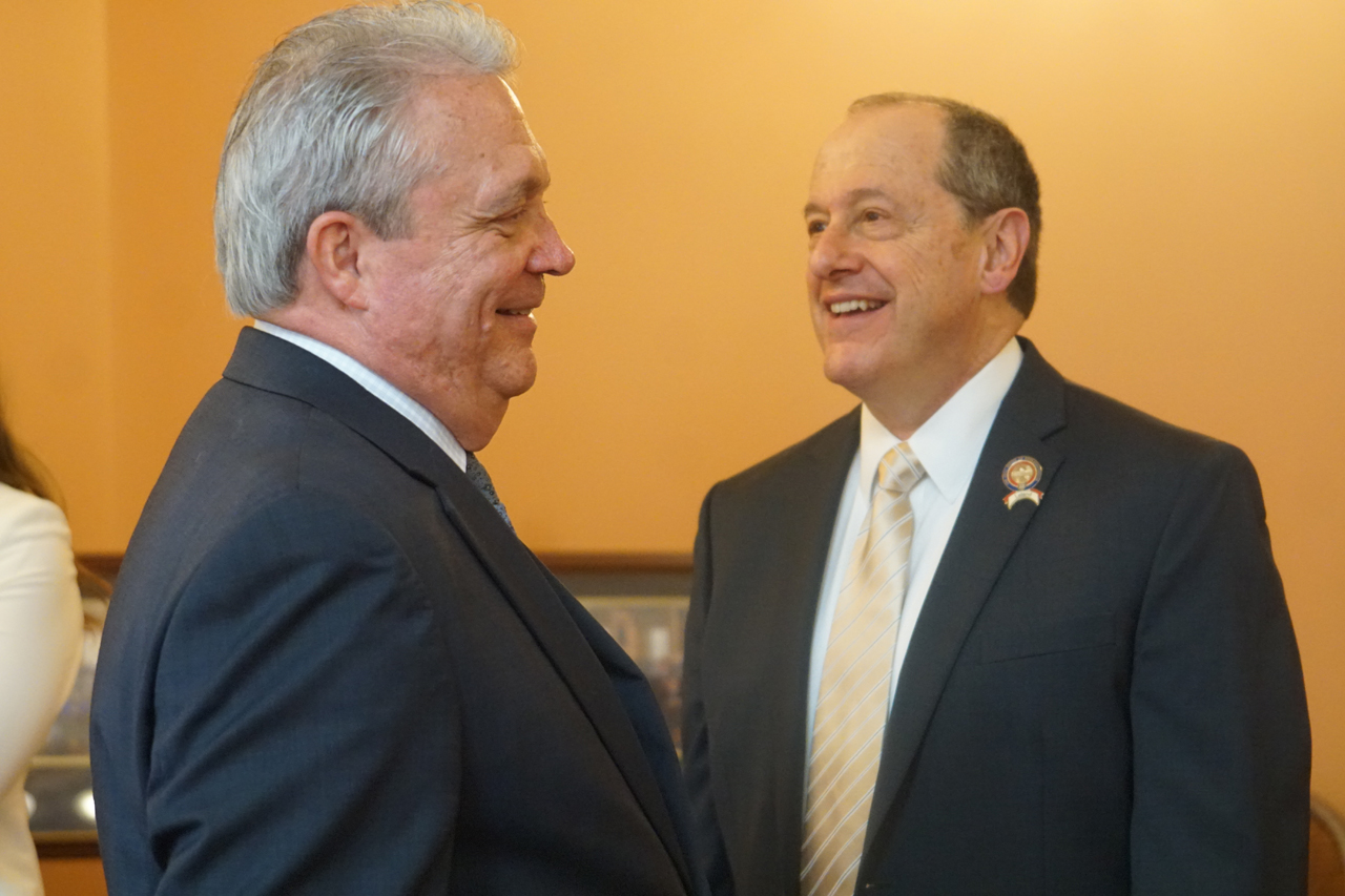 Rep. Brown speaks with Rep. David Leland (D-Columbus) before House session