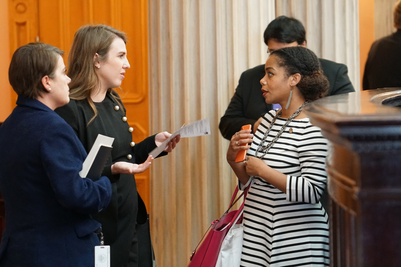 Rep. Sweeney talks with Rep. Erica C. Crawley (D-Columbus) before House Session