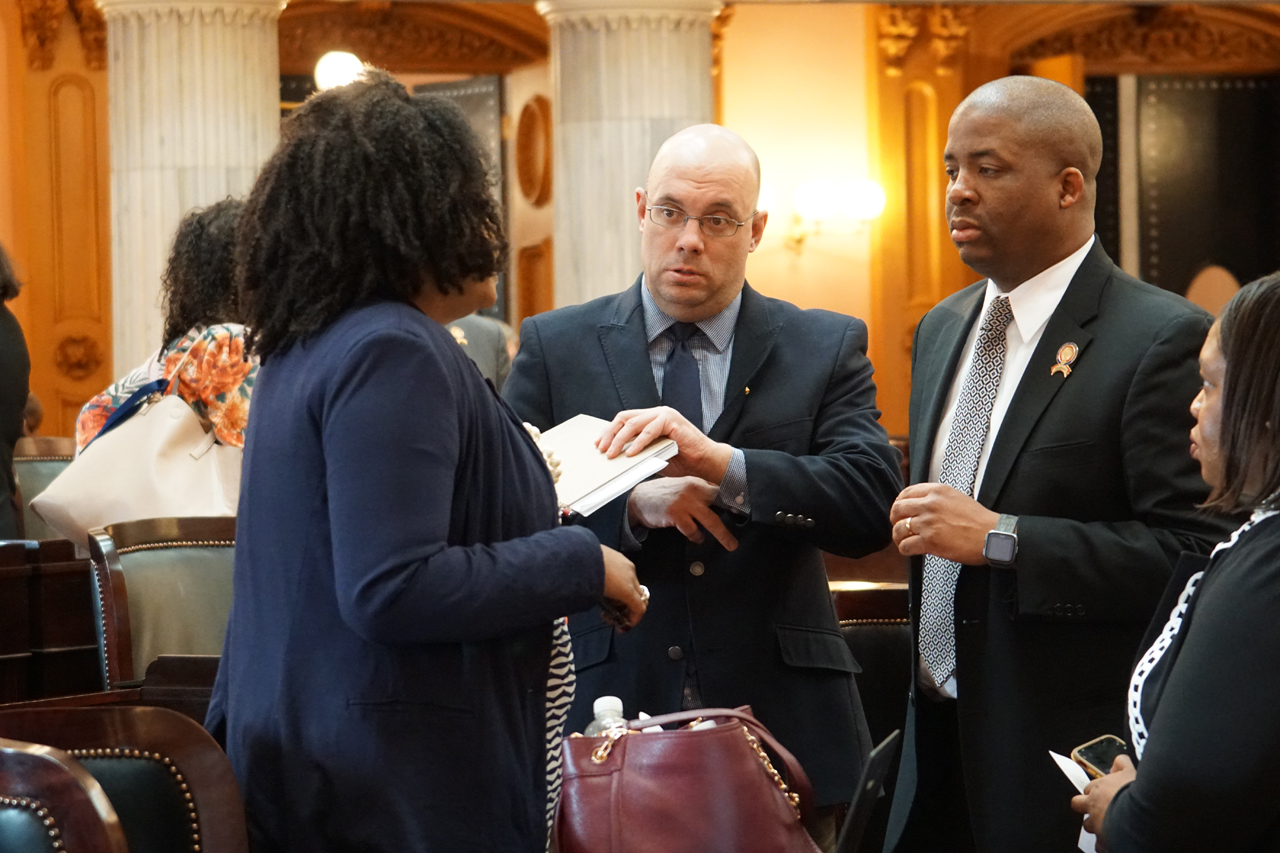 Rep. Robinson speaks with Reps. Stephanie Howse (D-Cleveland) and Jeff Crossman (D-Parma) after House Session