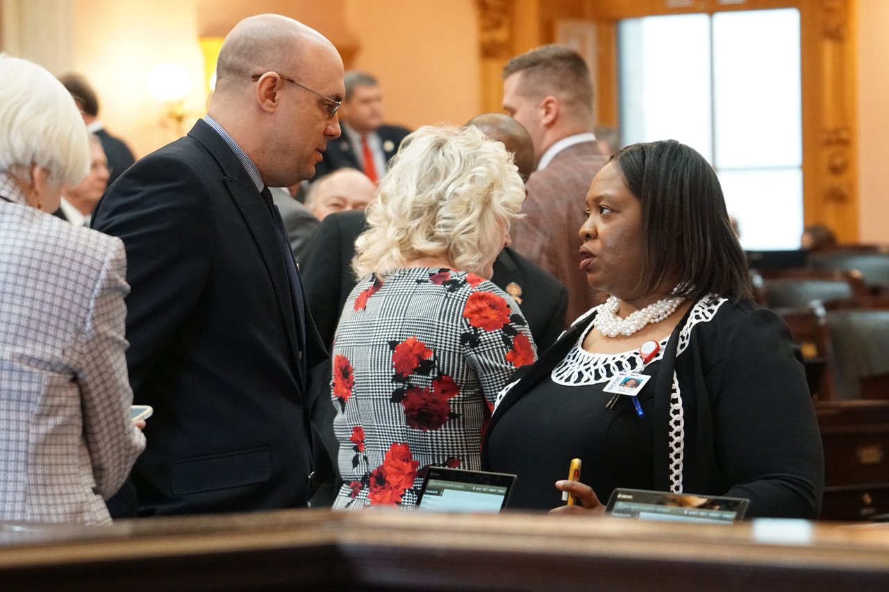 Rep. Crossman speaks with Rep. Juanita Brent (D-Cleveland) before House Session