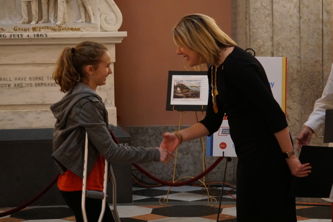 State Representative Allison Russo presents commendations to students participating in Kid Inventors Day at the Statehouse