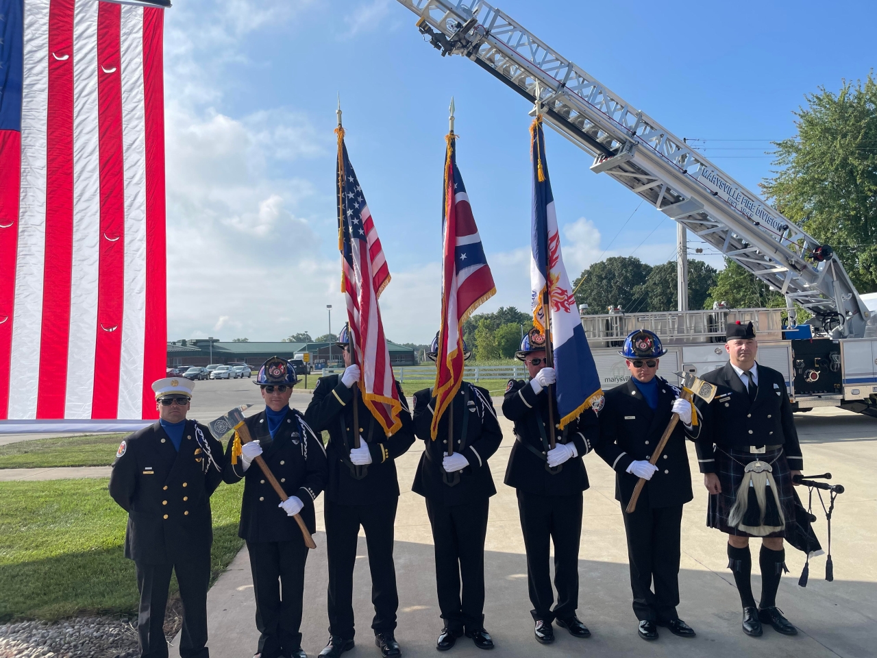 Representative Tracy Richardson salutes the flag at the Marysville Fire Division's 9/11 Remembrance Ceremony.