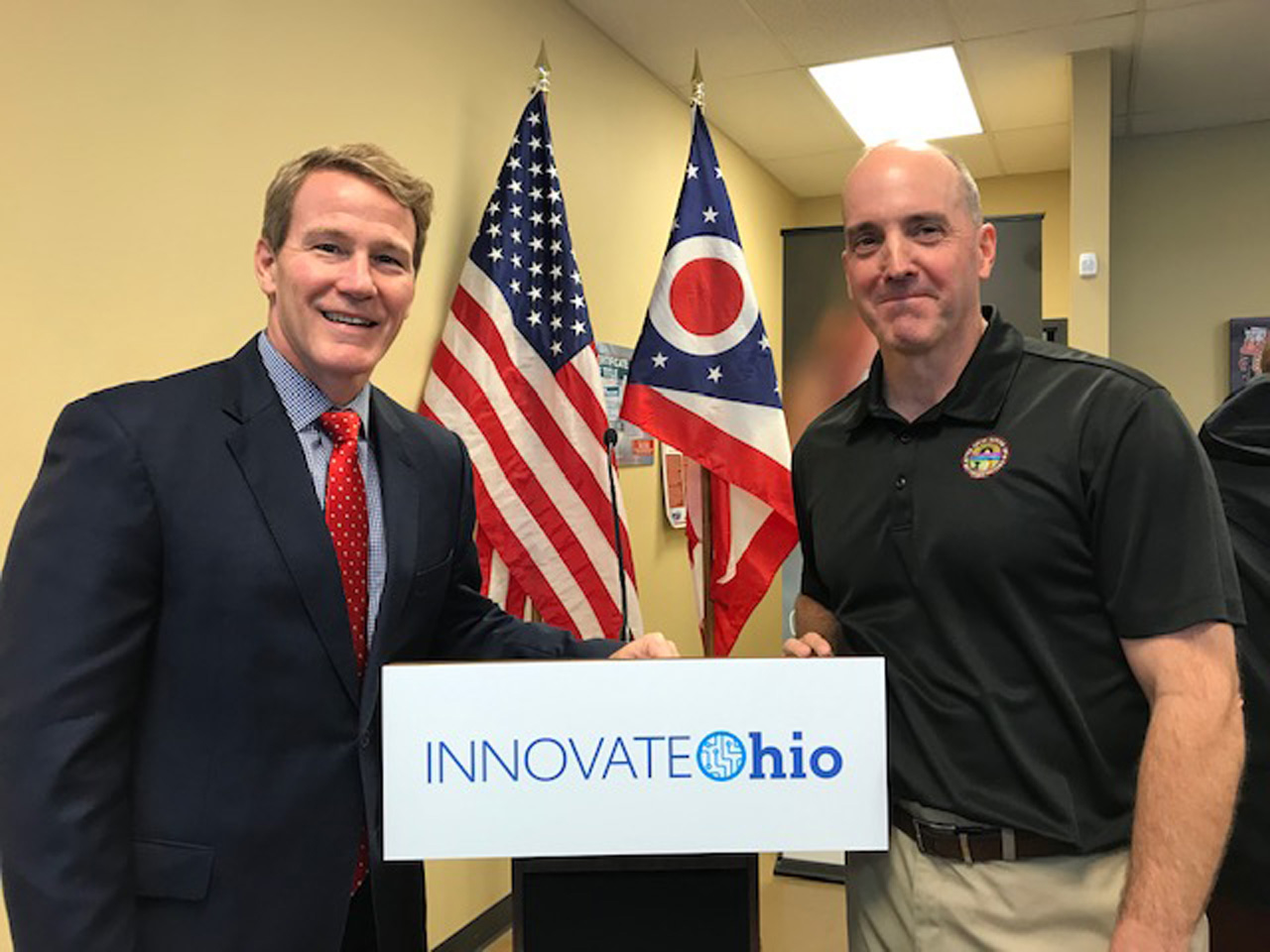 Rep. Holmes smiles with Lieutenant Governor Jon Husted at Muskingum County's DMV.