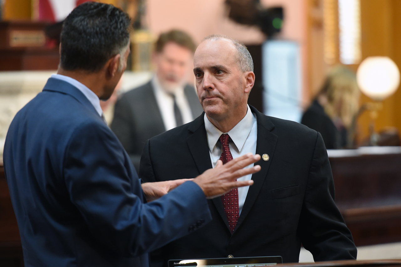 Rep. Holmes speaks with colleague Rep. Vitale before House session.