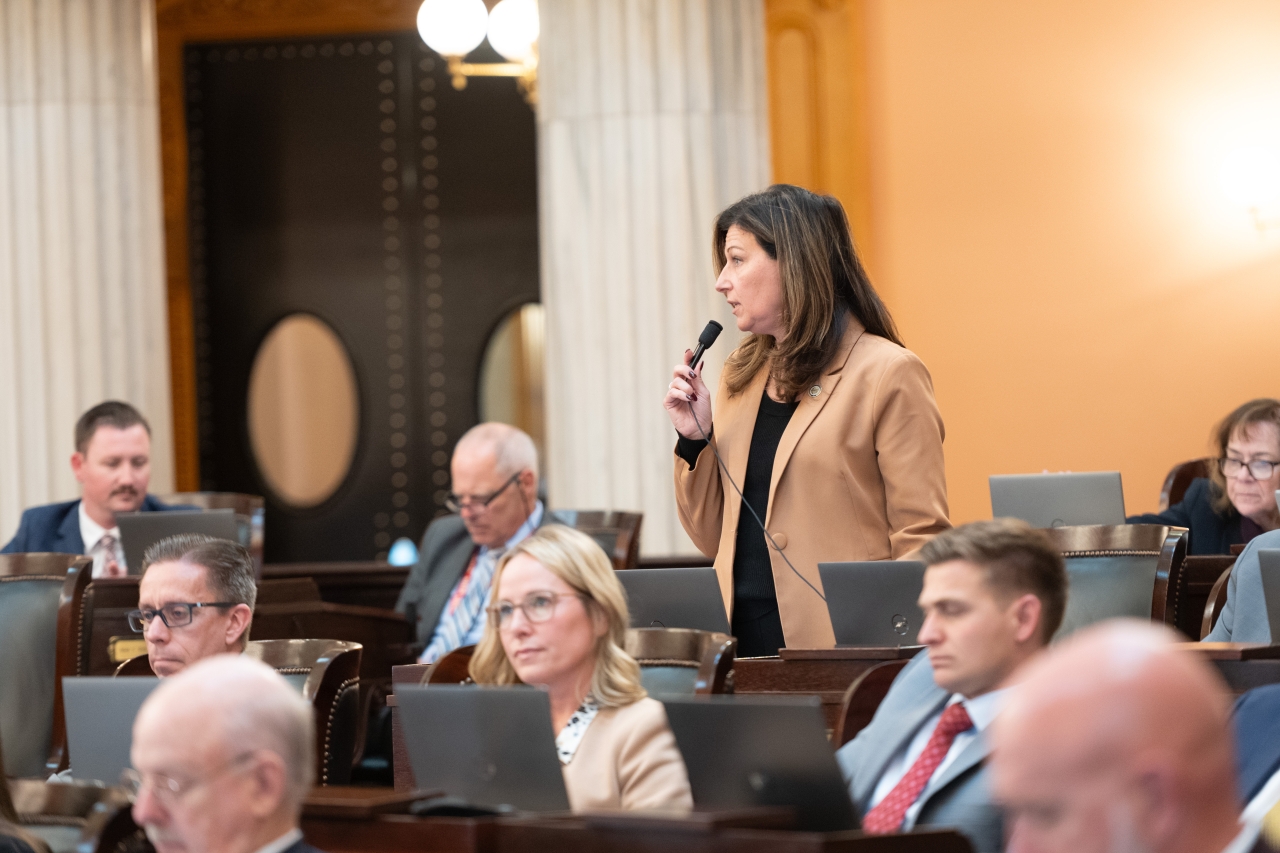 Rep. John speaks on the House floor during session