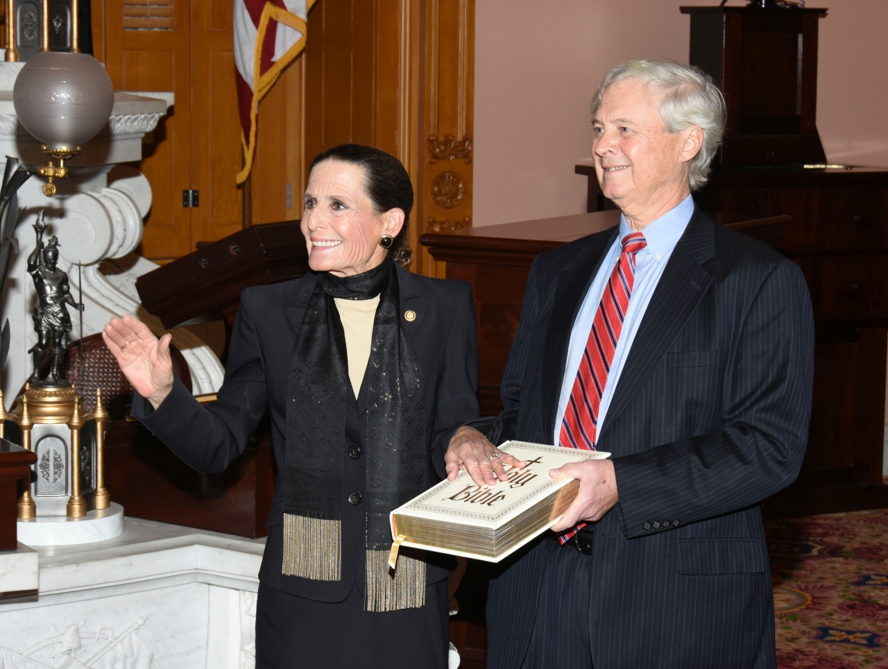 Rep. Schmidt stands alongside her husband as she takes the oath of office.