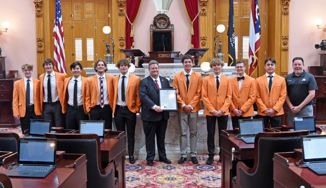 Representative Lampton presents the Beavercreek High School Boys Swim and Dive Team with a House Resolution honoring their Division I State Championship.