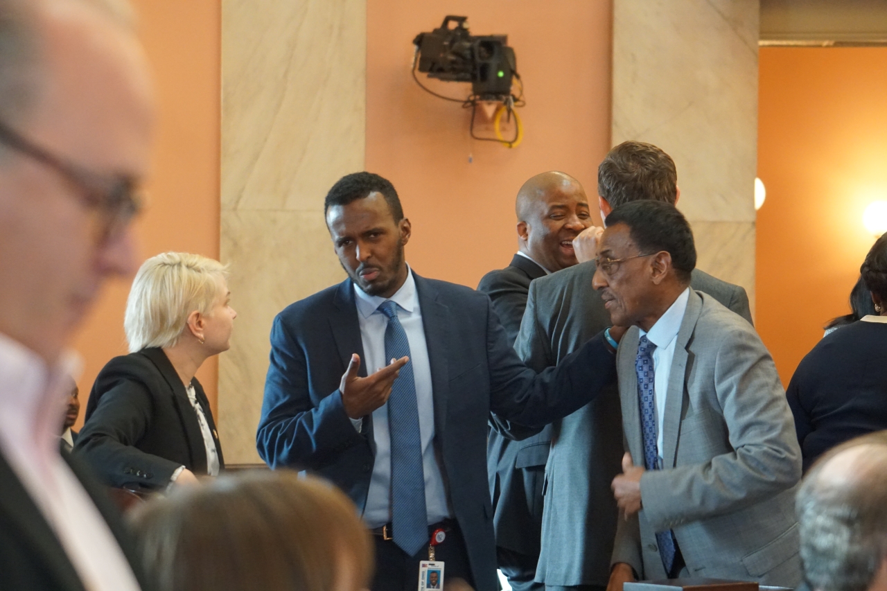 Rep. Mohamed talks with his fellow Democrats before the 2023 State of the State Address