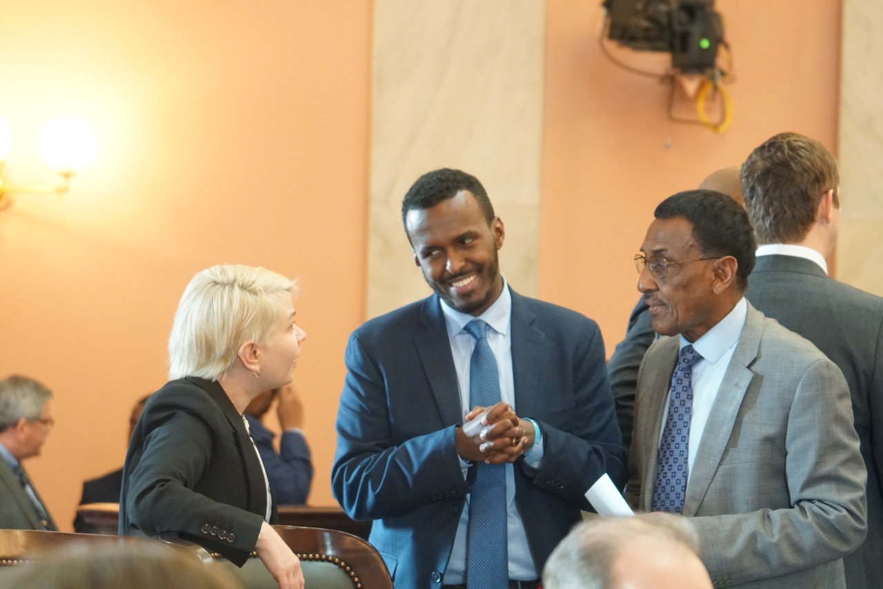 Rep. Mohamed talks with his fellow Democrats before the 2023 State of the State Address