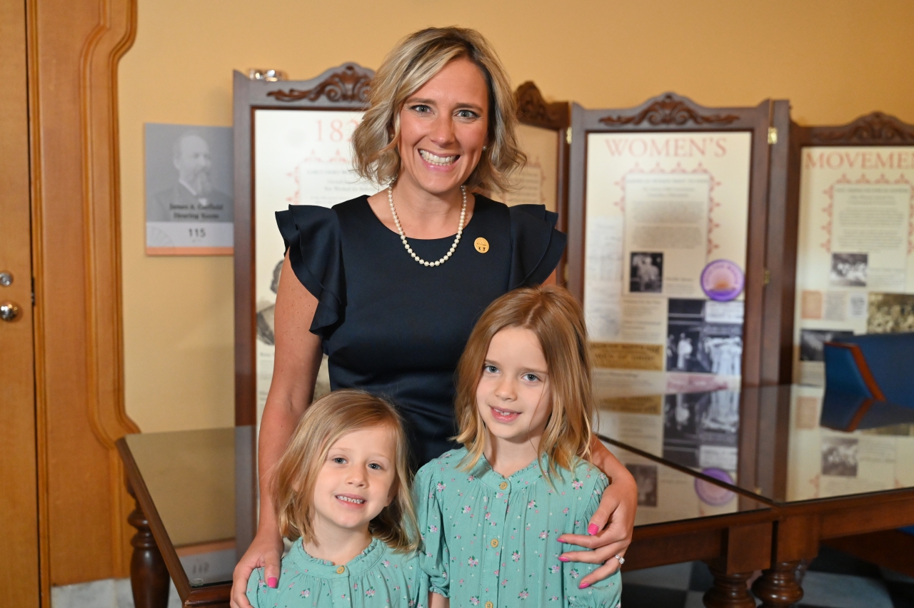 State Rep. Monica Robb Blasdel poses for a photo with here children in the Women's Gallery at the Statehouse.