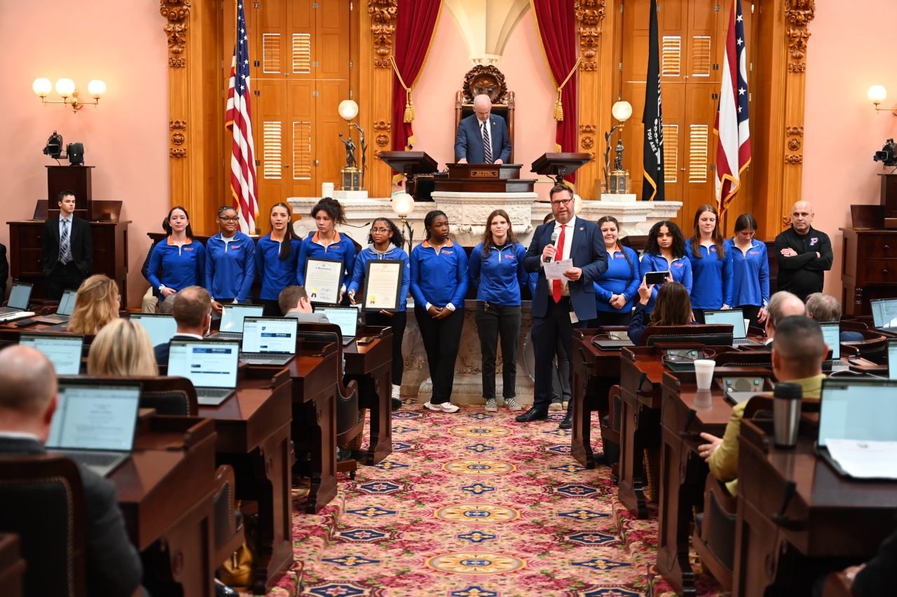 Representative Lorenz congratulating the Olentangy Orange Girl's wrestling team on winning the state championship.
