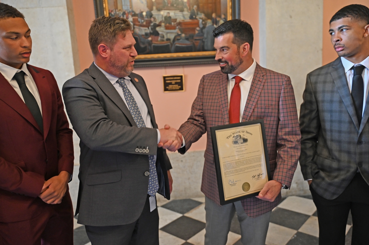 Representative Lorenz giving a commendation to Coach Ryan Day
