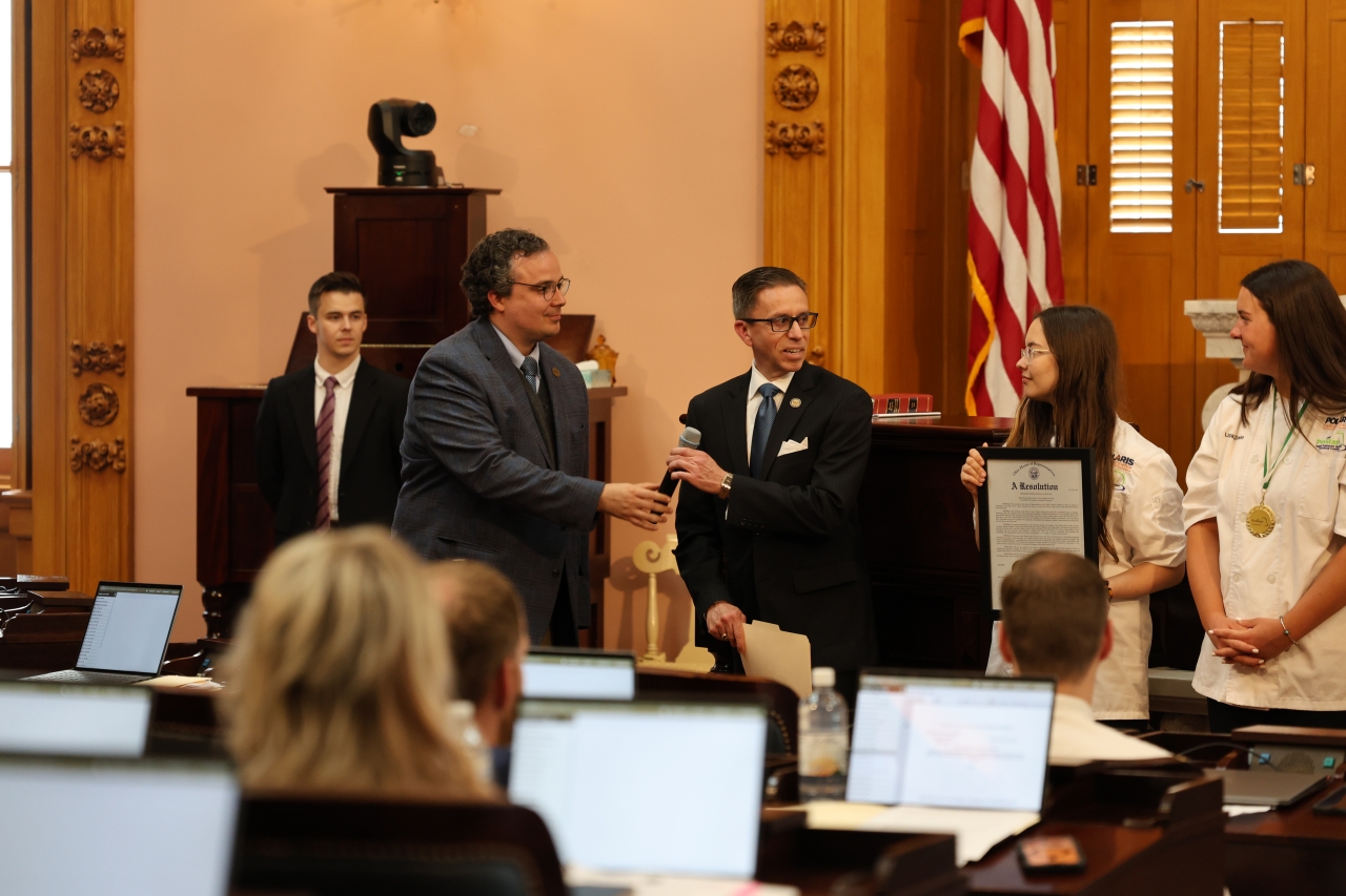 Rep Glassburn & Rep Dovilla present an official House Resolution to the Polaris Tech culinary team to celebrate their state title win.