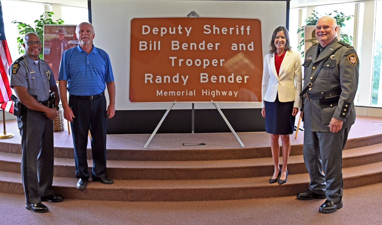 State Representative Tracy Richardson (R-Marysville) poses with, from left to right, Ohio Highway State Patrol Lt. Col. Charles Jones, Craig Massie and Marion County Sherriff Matt Bayles in front of the road sign that will designate a portion of state Route 309 in Marion County the Deputy Sherriff Bill Bender and Trooper Randy Bender Memorial Highway. The sign was unveiled at a ceremony Friday at the Marion County Sherriff’s office. 