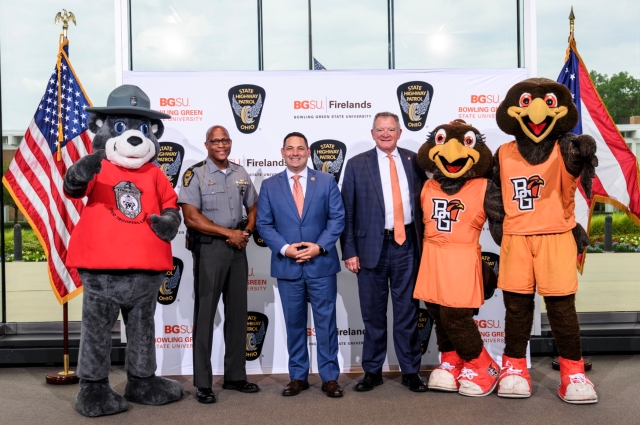 Ohio State Highway Patrol mascot Trooper Teddy, Patrol Superintendent Col. Charles A. Jones, state Rep. Haraz N. Ghanbari, Bowling Green State University President Rodney K. Rogers and BGSU mascots Frieda and Freddie Falcon pose for a photo during a ceremony at the Ohio State Highway Patrol Academy in Columbus. The event followed the announcement and signing of an agreement providing troopers and cadets a streamlined pathway to earn a college degree.